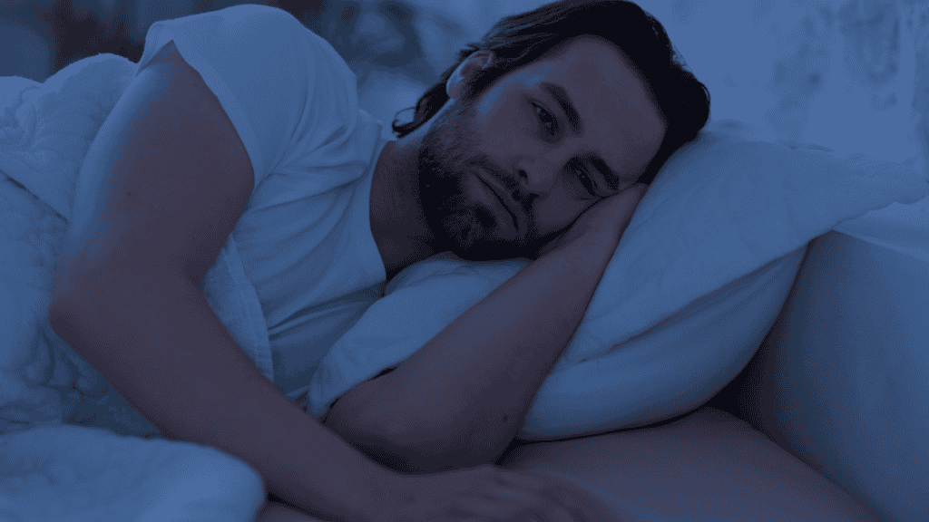 Man awake in bed at night